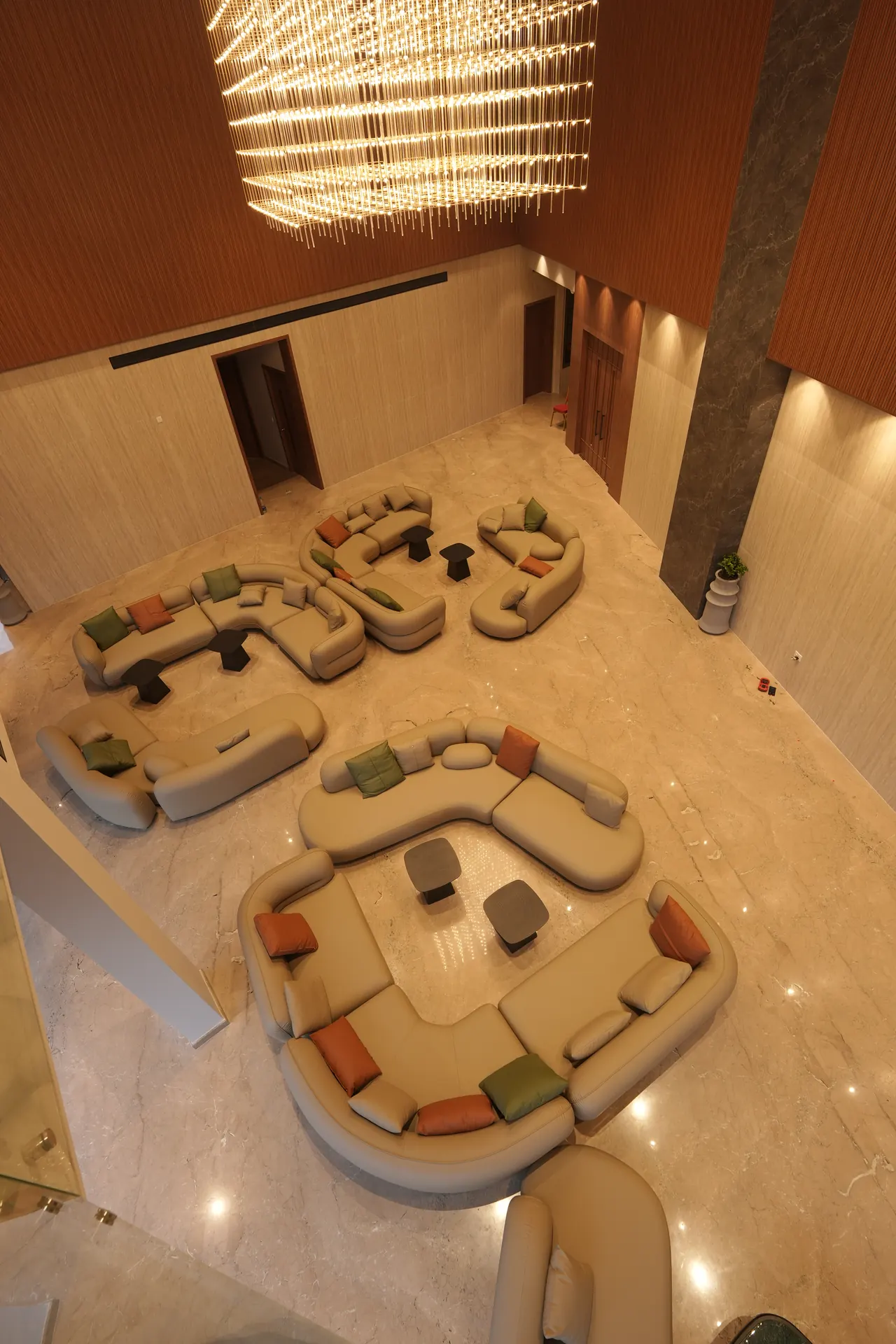 Lobby seating and chandelier seen from the mezzanine above