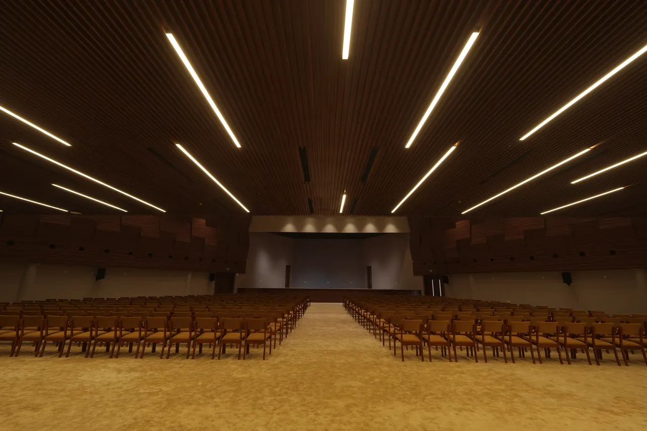 Main auditorium at Mountridge International, Manjeri, seating facing the stage beneath a slatted timber ceiling