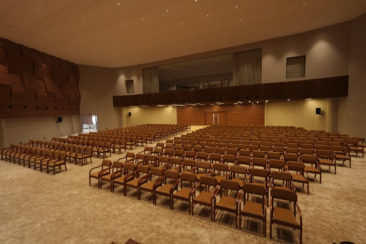View across the auditorium toward the rear mezzanine and glazed control gallery
